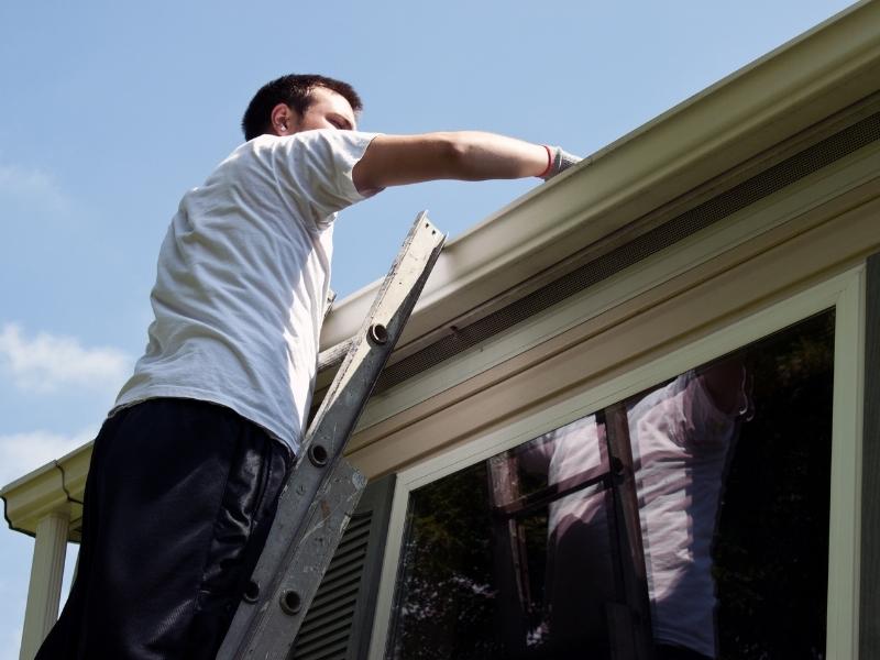 Man clearing gutters